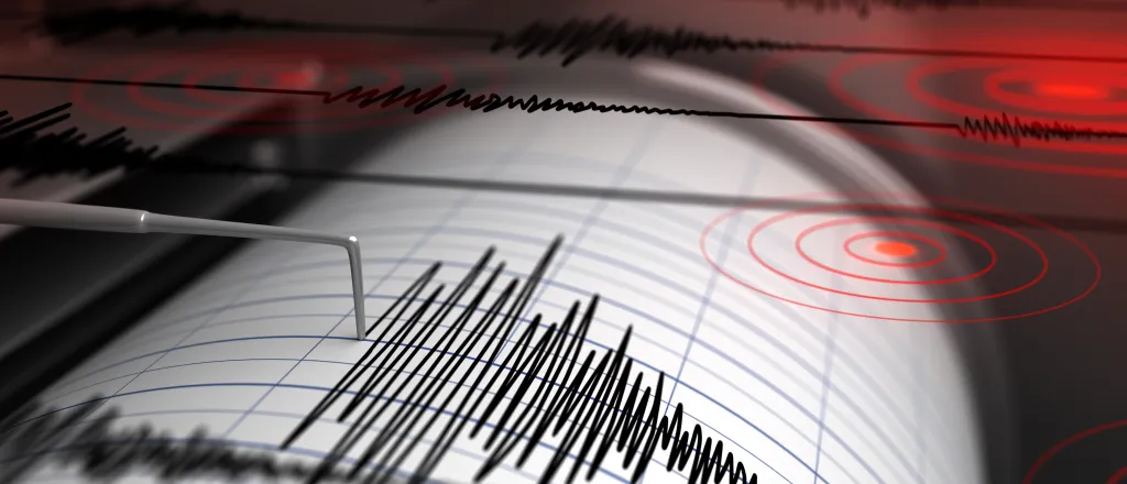 Earthquake seismograph drum with a stylus pen recording a large disturbance.